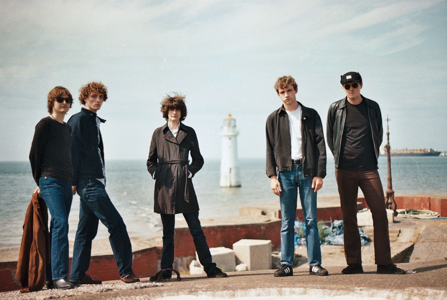 Five men stood on a pier